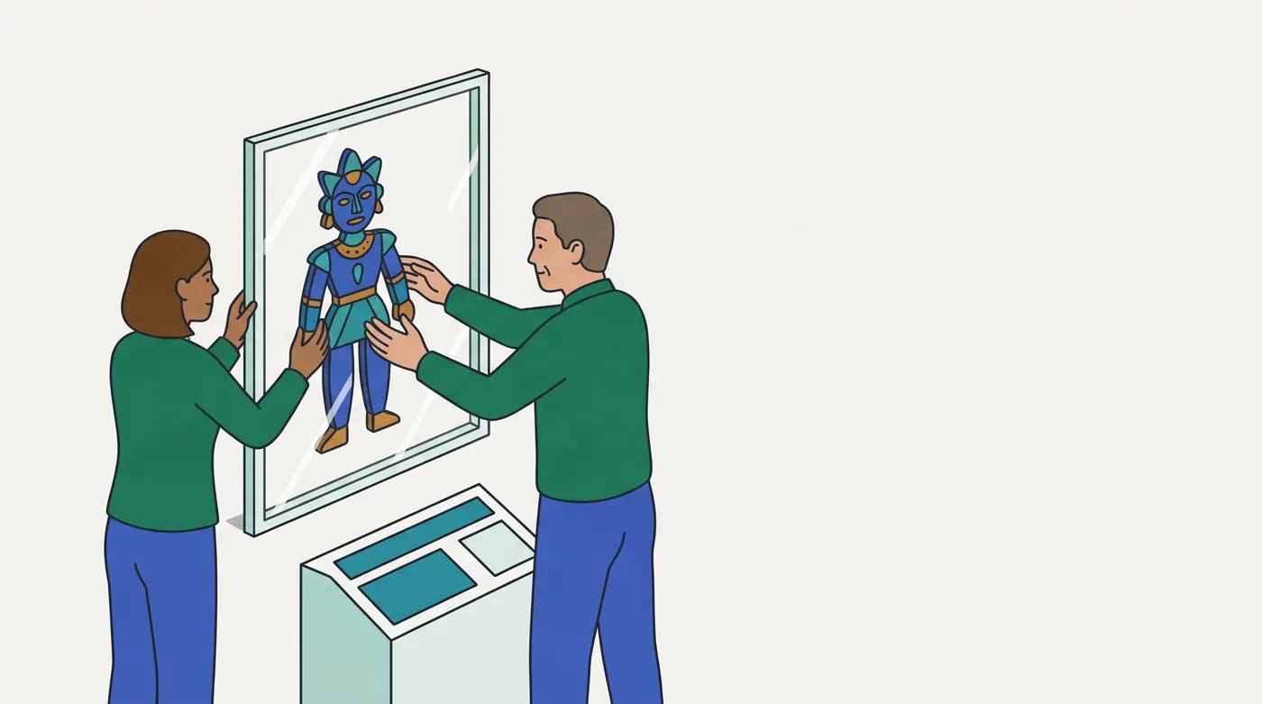 two people in green tops and blue trousers — a woman on the left, a man on the right — placing a blue-and-teal decorative marionette behind a tall clear framed glass panel that stands on the floor. A separate pale pedestal with a teal touch-panel stands in front of the panel, lower down. The puppet is displayed behind the glass rather than handed the controls.